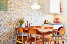 26 a colorful modern kitchen and dining zone accented with colorful floral wallpaper and with bright accessories for fun