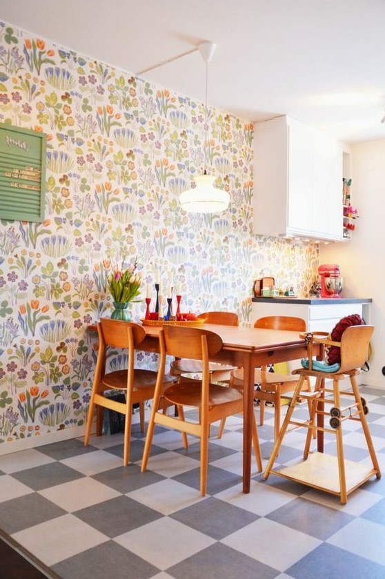 a colorful modern kitchen and dining zone accented with colorful floral wallpaper and with bright accessories for fun