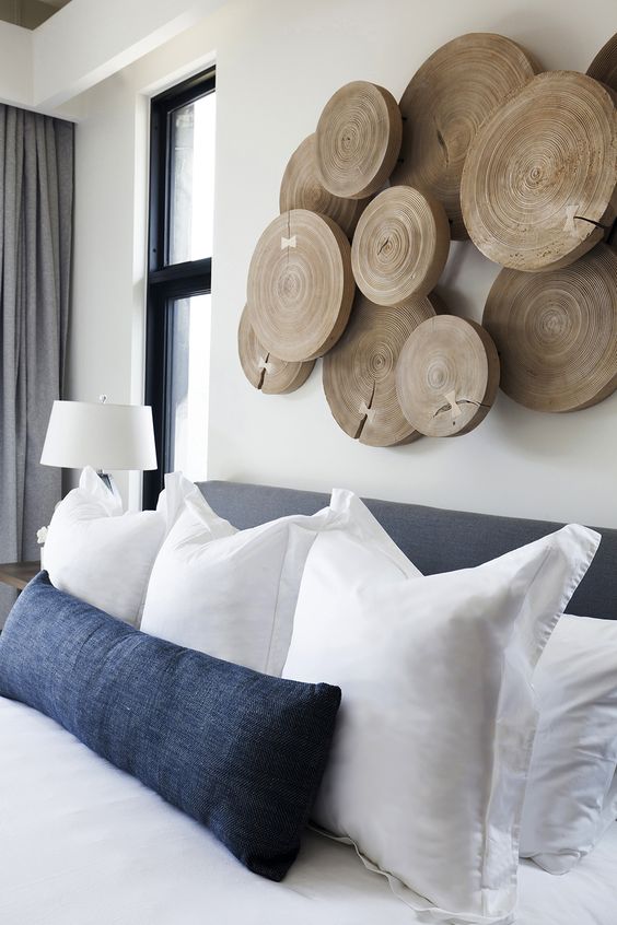 a tree slice wall art makes a statement instead of a large statement headboard and it looks gorgeous