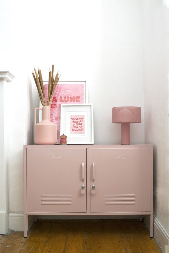 a dusty pink locker unit with various decor can easily match many spaces, and its delicate will makes it look softer