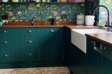 28 a dark green kitchen with bright floral wallpaper, an open shelf and butcherblock countertops, a hexagon tile floor