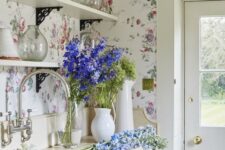 32 a vintage farmhouse kitchen in neutrals and with lovely pink and blue floral wallpaper that creates a mood here