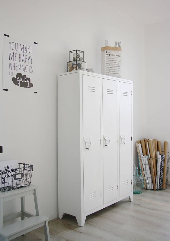 a craft room completed with white lockers that are used for storing all the stuff you want and need