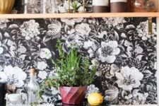 35 a white kitchen accented with elegant black and white floral wallpaper, white square tiles and with an open shelf for storage and display