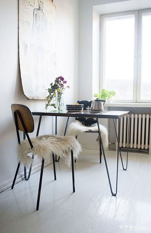 a Scandinavian dining space wiht a table with hairpin legs, chairs, some greenery and blooms is a lovely space to have meals