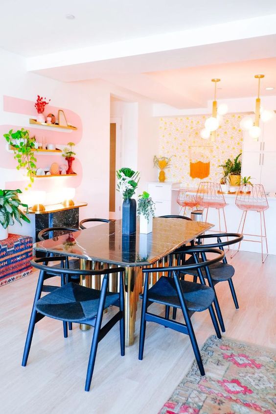 a white kitchen with flat panel cabinets, tall pink stools, floral wallpaper, a dining zone with elegant mid century modern furniture