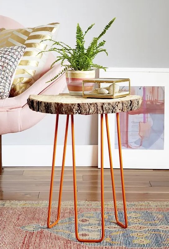 a side table of a tree slice and orange hairpin legs is a cool decor piece for a living room in mid-century modern style