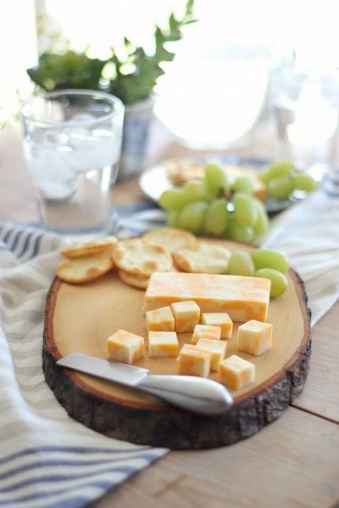 a tree slice serving board is a great idea to display some appetizers and it can be a nice fit for a rustic interior