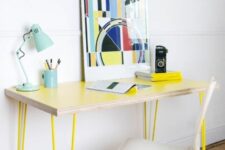 39 a sleek and delicate lightweight desk with neon yellow hairpin legs, a bold artwork, a blue table lamp and white chair