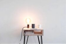 45 a small nightstand of a box and hairpin legs, with a bulb lamp is a stylish idea for a modern or Scandinavian space