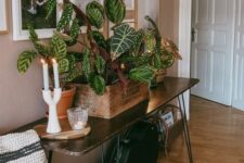 50 an elegant dark-stained hairpin leg console table with potted plants and candles is a chic and cool idea for a modern space