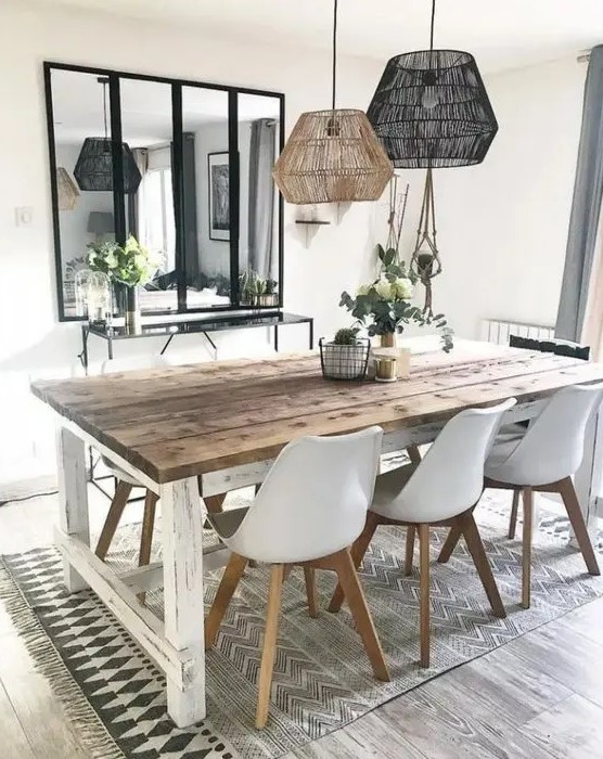 a Nordic dining room with a whitewashed table, Eames chairs, matching pendant lamps and a sleek console table