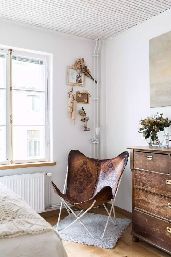a beautiful leather printed butterfly chair paired up with a shabby chic dresser looks lovely and creates a cozy feel in the space