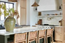 a beautiful modern kitchen with stained cabinets and a dark green kitchen island, white stone countertops and woven stools