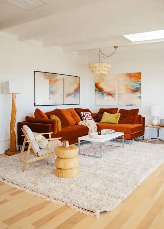 a bold living room with a rust-colored modern sectional and a bright gallery wall plus statement lamps