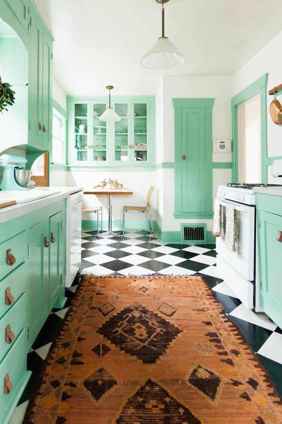 https://www.digsdigs.com/photos/2023/03/a-bright-mint-kitchen-with-shaker-cabinets-and-leather-handles-a-bold-boho-rug-and-a-checked-floor-plus-pendant-lamps.jpg