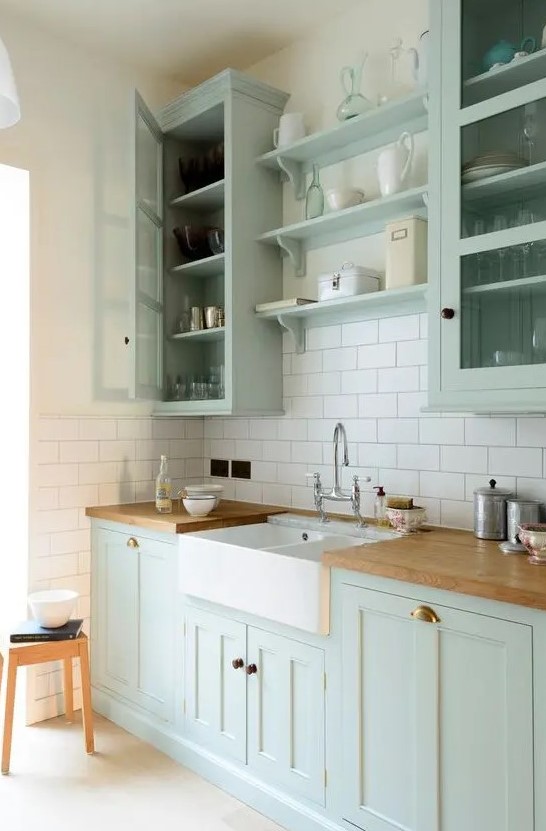 https://www.digsdigs.com/photos/2023/03/a-chic-mint-green-farmhouse-kitchen-with-shaker-style-cabinets-butcherblock-countertops-a-white-subway-tile-backsplash-and-a-vintage-faucet.jpg