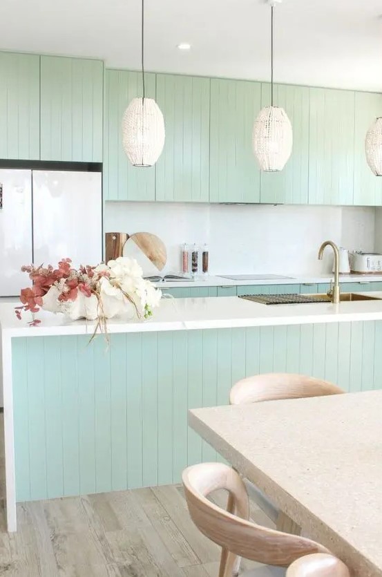 https://www.digsdigs.com/photos/2023/03/a-chic-mint-green-slatted-kitchen-with-a-white-backsplash-and-countertops-cool-pendant-lamps-a-terrazzo-table-and-stained-chairs.jpg