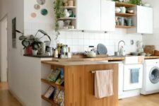 a cozy modern kitchen with flat white cabinets and open ones, stained shelves and butcherblock countertops, potted plants