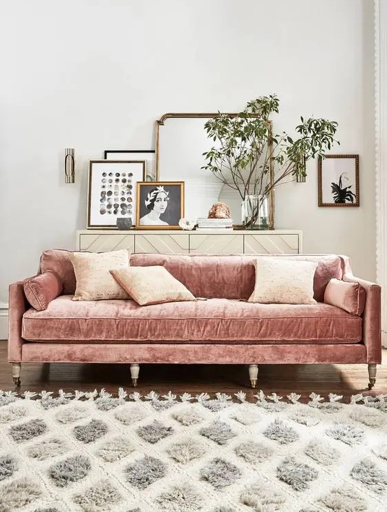a dusty pink velvet sofa will enliven a neutral living room and make it look softer and cuter