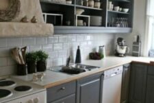 a graphite grey kitchen with shaker and open cabinets, a white subway tile backsplash, white countertops and a large hood