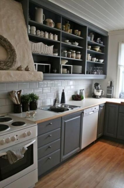 a graphite grey kitchen with shaker and open cabinets, a white subway tile backsplash, white countertops and a large hood
