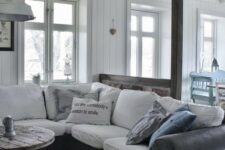 a graphite grey leather sofa cover with white cushions is a perfect match for a Scandinavian interior