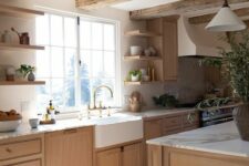 a lovely earthy modern kitchen with light-stained lower cabinets and a kitchen island, rough wooden beams, open shelves
