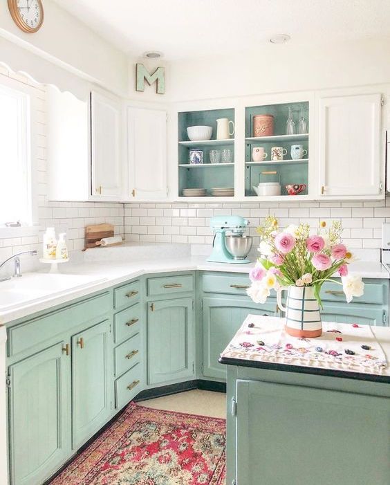 a mint and white kitchen with open cabinets, a white subway tile backsplash, a kitchen island and white countertops