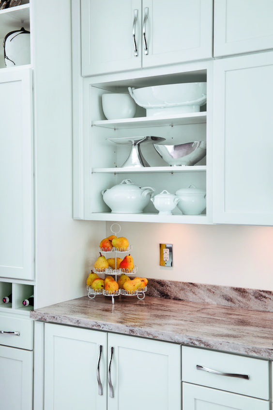 a mint blue kitchen with shaker cabinets, an open compartment in an upper cabinet, stone countertops is a chic idea