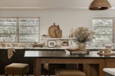 a modern earthy kitchen with dark lower cabinets, a stained kitchen island with an eating zone, a pendant lamp and open shelves