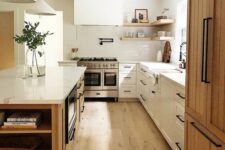 a modern earthy kitchen with white shaker cabinets, a stained kitchen island and a cupboard, black handles and open shelves