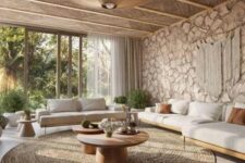 a modern earthy living room with a tropical feel, a stone accent wall, a wooden ceiling, a large rug, white sofas and chairs, potted greenery