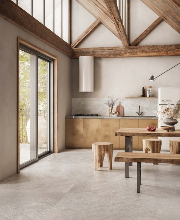 a modern earthy tone kitchen with stained wooden beams, plywood lower cabinets, a marble tile backsplash and a stone tile floor