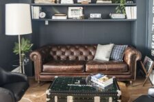 a modern home office with a brown leather Chesterfield sofa, black chairs, a chest table and a faux animal skin rug