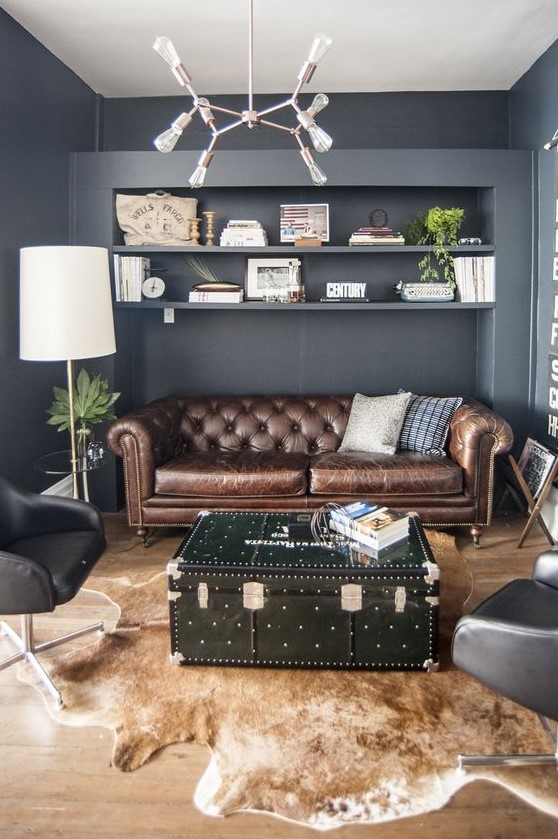a modern home office with a brown leather Chesterfield sofa, black chairs, a chest table and a faux animal skin rug
