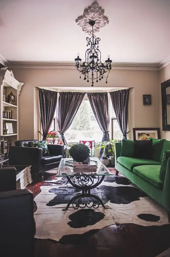 a moody living space with a bold splash - an emerald green velvet Stockholm sofa that makes a statement