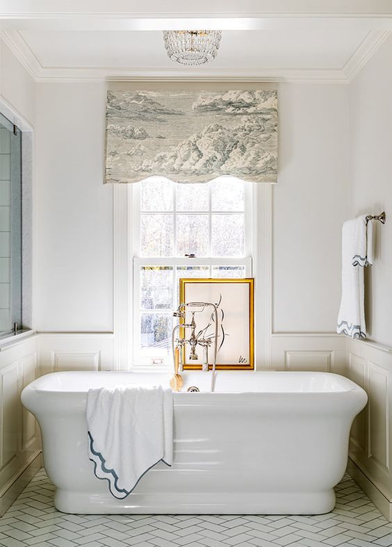 a neutral vintage bathroom with paneling, a large tub, a double hung window, a printed curtain and an artwork