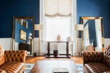 a refined living room with two mustard leather tufted sofas as the main pieces for a conversation space