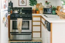 a small and lovely kitchen with white and stained opn cabinets that are used for displaying dishes, jars and potted plants
