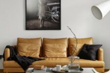 a stylish monochromatic living room in contemporary style, with a yellow leather sofa as a colorful statement