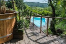 a small deck with a hot tub