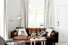a welcoming neutral living room with a brown leather sofa, a leather stool and a grey chair is cool and stylish