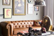 a whimsical industrial living room with a brown leather Chesterfield sofa, a bold and quirky gallery wall and a metal table