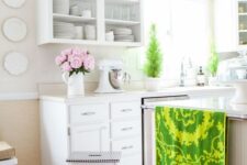 a bright kitchen with white cabients and an IKEA stool