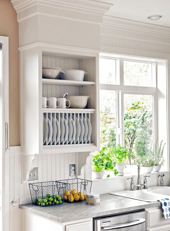 a white farmhouse kitchen with flat panel and open cabinets, a white beadboard backsplash, grey countertops is veyr cozy