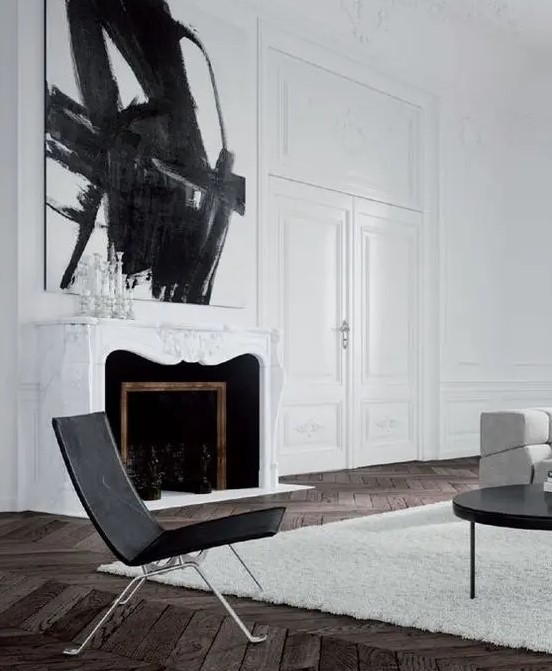 a white marble-clad French fireplace with black inside is a beautiful and refined addition to the living room