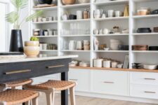 a whole wall taken by open cabinets that are used to display beautiful dishes, vases, cutting boards and other kitchen stuff