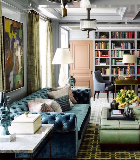 an eclectic living room with a muted blue velvet sofa and other touches of color for interest