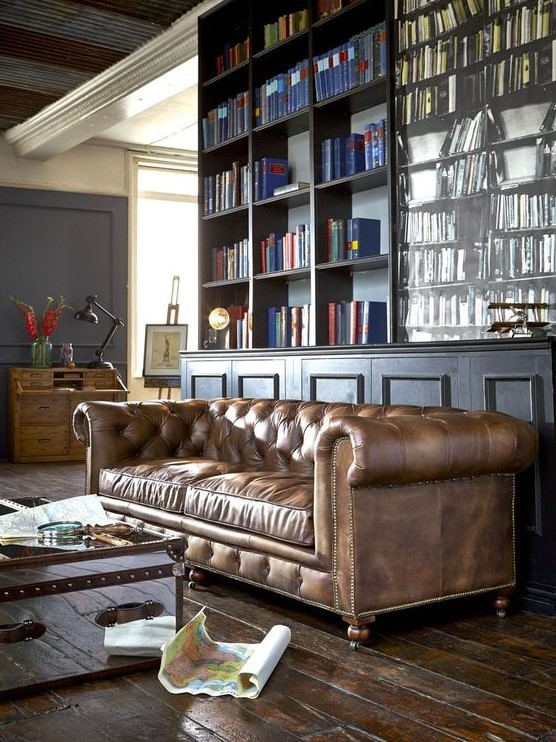 an elegant moody home office with a brown leather Chesterfield sofa that is a centerpiece here